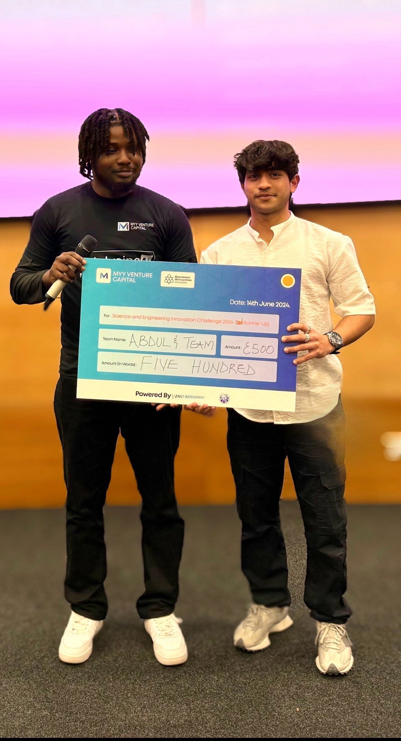 Abdul Sait and team member celebrating their £500 prize as 2nd Runner Up